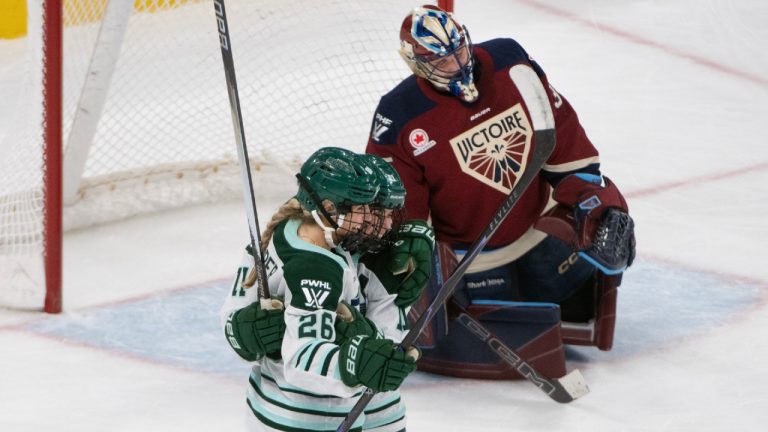 Boston Fleet's Ella Huber (26) celebrates with Boston Fleet's Alina Muller (11) as Montreal Victoire goaltender Ann-Renee Desbiens (35) reacts after Huber’s ovetime goal to clinch a victory during PWHL hockey action in Laval, Quebec on Sunday March 15, 2026. (/Peter McCabe/CP)