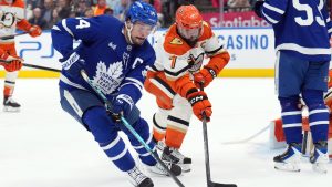 Toronto Maple Leafs Auston Matthews (34) and Anaheim Ducks Radko Gudas (7) battle for the puck during second period NHL hockey action in Toronto on Thursday, March 12, 2026. (Nathan Denette/CP)