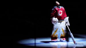 A spotlight illuminates Ottawa Charge goaltender Gwyneth Philips as she stands on the ice for player introductions before first-period PWHL playoff hockey action against the Montreal Victoire in Ottawa, on Tuesday, May 13, 2025. (Photo by Justin Tang/CP)