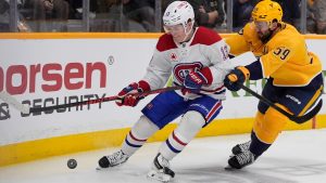 Montreal Canadiens right wing Cole Caufield (13) chases the puck past Nashville Predators defenseman Roman Josi (59) during the first period of an NHL hockey game Saturday, March 28, 2026, in Nashville, Tenn. (George Walker IV/AP)