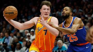 Charlotte Hornets guard Kon Knueppel (7) drives against New York Knicks guard Mikal Bridges during the second half of an NBA basketball game in Charlotte, N.C., Thursday, March 26, 2026. (AP Photo/Nell Redmond)