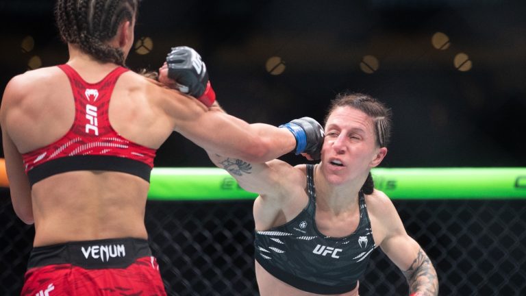 Jamey-Lyn Horth, right ,takes a punch from Ivana Petrovic during the women's flyweight bout at UFC Fight Night in Edmonton on Saturday, Nov. 2, 2024. Canadian flyweight Horth waited 11 months for her last UFC fight. (THE CANADIAN PRESS/Jason Franson)