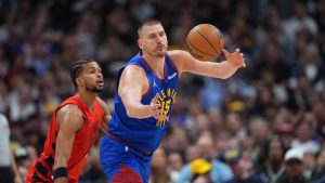 Denver Nuggets centre Nikola Jokic juggles the ball as Portland Trail Blazers forward Toumani Camara defends in the first half of an NBA game Sunday, March 22, 2026, in Denver. (AP/David Zalubowski)