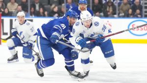 Tampa Bay Lightning left wing Brandon Hagel battles for the puckToronto Maple Leafs John Tavares during third period NHL action in Toronto, Monday, Dec. 8, 2025. (THE CANADIAN PRESS/Chris Young)