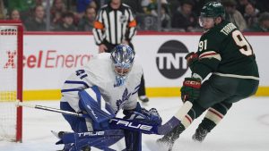 Toronto Maple Leafs goaltender Dennis Hildeby (41) blocks a shot while pressured by Minnesota Wild right wing Vladimir Tarasenko (91) during the first period of an NHL hockey game, Sunday, March 15, 2026, in St. Paul, Minn. (Abbie Parr/AP)