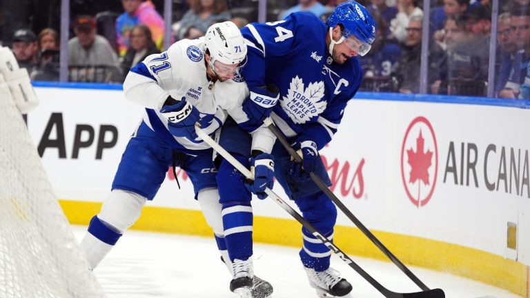 Toronto Maple Leafs Auston Matthews (34) and Tampa Bay Lightning Anthony Cirelli (71) battle for the puck during first period NHL action in Toronto, on Saturday, March 7, 2026. (Frank Gunn/CP)