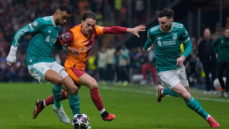 Liverpool's Cody Gakpo, left, and Andrew Robertson, right, fight for the ball with Galatasaray's Yunus Akgun during a Champions League round of 16 first leg soccer match between Galatasaray and Liverpool, in Istanbul, Turkey, Tuesday, March 10, 2026. (Khalil Hamra/AP)