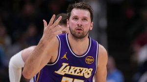 Los Angeles Lakers guard Luka Doncic (77) gestures after a three-point basket against the Indiana Pacers during the first half of an NBA basketball game in Indianapolis, Wednesday, March 25, 2026. (Michael Conroy/AP)