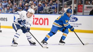 Toronto Maple Leafs' Max Domi, left, controls the puck while St. Louis Blues' Robert Thomas (18) defends during the first period of an NHL hockey game Saturday, March 28, 2026, in St. Louis. (Connor Hamilton/AP)