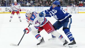 Toronto Maple Leafs forward Nicholas Robertson (89) checks New York Rangers forward Tye Kartye (24) during first period NHL hockey action in Toronto, Wednesday, March 25, 2026. (Nathan Denette/CP)