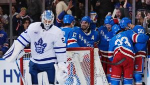 New York Rangers' Mika Zibanejad (93) celebrates with teammates after scoring a goal as Toronto Maple Leafs goaltender Joseph Woll looks down during the third period of an NHL hockey game Thursday, March 5, 2026, in New York. (Frank Franklin II/AP)