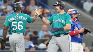 Seattle Mariners' Randy Arozarena (56) and Cal Raleigh celebrate after scoring on a three run home run from teammate Jorge Polanco during fifth inning American League Championship Series baseball action in Toronto on Monday, Oct. 13, 2025. THE CANADIAN PRESS/Frank Gunn