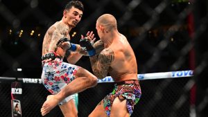 Max Holloway, left, kicks Dustin Poirier in a lightweight BMF Title fight at UFC 318 in New Orleans. (Ella Hall/AP)
