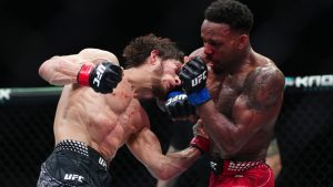 Movsar Evloev, left, punches Lerone Murphy during a featherweight bout at UFC Fight Night mixed martial arts fights in London, Saturday March 21, 2026. (Bradley Collyer/PA via AP)