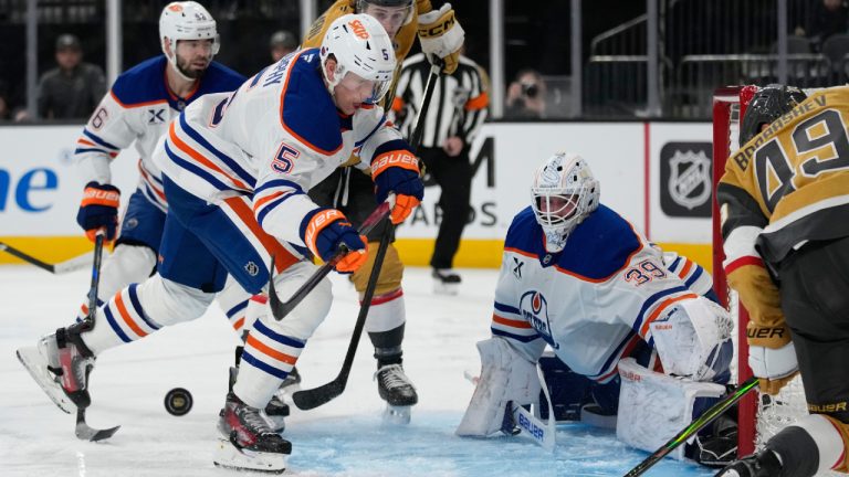 Edmonton Oilers defenceman Connor Murphy (5) knocks the puck away against the Vegas Golden Knights during the second period of an NHL hockey game Sunday, March 8, 2026, in Las Vegas. (John Locher/AP)