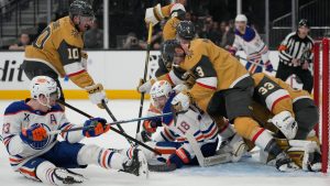 Vegas Golden Knights and Edmonton Oilers players battle for the puck during the first period of an NHL hockey game Thursday, March 26, 2026, in Las Vegas. (John Locher/AP)