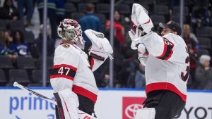 Ottawa Senators goalies James Reimer, left, and Linus Ullmark celebrate after Ottawa defeated the Vancouver Canucks 2-0 during an NHL hockey game, in Vancouver, on Monday, March 9, 2026. (Darryl Dyck/CP)