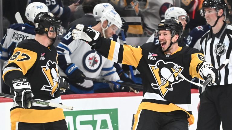 Pittsburgh Penguins right wing Rickard Rakell (67) celebrates after center Sidney Crosby (87) scored the game-winning goal against the Winnipeg Jets in a shootout during an NHL game, Saturday, March 21, 2026, in Pittsburgh. (AP Photo/Philip G. Pavely)