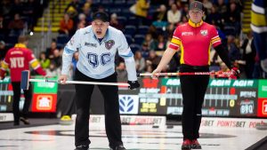 Jean-Michel Menard, left to right, skip of Team Quebec calls out to his sweepers as Christian Smitheran, of Team Nunavut, looks on during Draw 13 at the Montana's Brier Canadian men's curling championship, in St. John's, N.L., on Wednesday, March 4, 2026. (Paul Daly/CP)