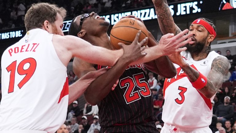 Chicago Bulls centre Jalen Smith, centre, battles for a ball against Toronto Raptors centre Jakob Poeltl, left, and forward Brandon Ingram during the first half of an NBA basketball game in Chicago, Wednesday, March 18, 2026. (Nam Y. Huh/AP)
