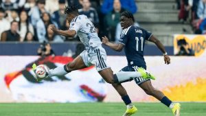 San Jose Earthquakes' DeJuan Jones (24) and Vancouver Whitecaps' Emmanuel Sabbi (11) vie for the ball during the first half of an MLS soccer match in Vancouver, on Saturday, March 21, 2026. (Ethan Cairns/CP)