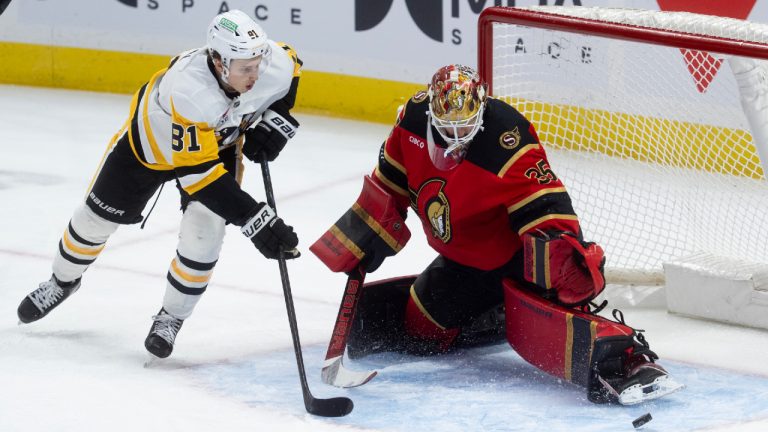 Pittsburgh Penguins centre Ben Kindel (81) chases the puck as it deflects off Ottawa Senators goaltender Linus Ullmark (35) during first period NHL action in Ottawa, Thursday, March 26, 2026. (Adrian Wyld/CP)