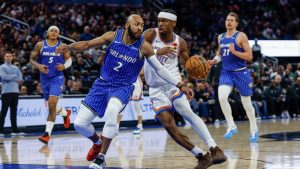 Orlando Magic guard Jevon Carter (2) defends Oklahoma City Thunder guard Shai Gilgeous-Alexander, right, during the second half of an NBA basketball game Tuesday, March 17, 2026, in Orlando, Fla. (Kevin Kolczynski/AP)