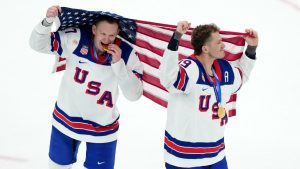 United States' Brady Tkachuk (7) and Matthew Tkachuk (19) celebrate after the United States' win over Canada in the men's ice hockey gold medal game at the 2026 Winter Olympics in Milan, Italy, Sunday, Feb. 22, 2026. (Carolyn Kaster/AP)
