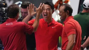 Jupiter Links Golf Club players, from right, Tiger Woods, Tom Kim, and Kevin Kisner celebrate as they defeat Boston Common Golf in overtime during a match of the TMRW Golf League, Monday, Jan. 27, 2025, in Palm Beach Gardens, Fla. (AP/Rebecca Blackwell)
