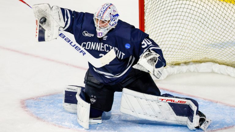 UConn goalie Tyler Muszelik (30) blocks a shot during the third period of an NCAA hockey regional game against Michigan State on Thursday, March 26, 2026, in Worcester, Mass. (Greg M. Cooper/AP)