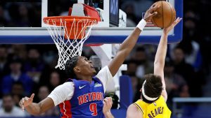 Detroit Pistons guard Ausar Thompson (9) blocks a shot-attempt by Los Angeles Lakers guard Austin Reaves (15) during the first half of an NBA basketball game Monday, March 23, 2026, in Detroit. (AP Photo/Duane Burleson)