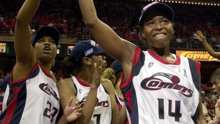 In this Aug. 26, 2000, file photo, Houston Comets' Cynthia Cooper (14) waves to the crowd after being named WNBA Championship MVP in Houston. The Comets beat the New York Liberty 79-73 to win their fourth consecutive championship. Also celebrating are Tammy Jackson (23) and Tina Thompson (7). WNBA president Donna Orender says the franchise that won the league's first four championships is disbanding. (AP Photo/Pat Sullivan, File)