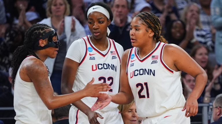 UConn's KK Arnold, left, Serah Williams (22) and Sarah Strong (21) celebrate late in the second half in the Sweet 16 of the NCAA college basketball tournament against North Carolina, Friday, March 27, 2026, in Fort Worth, Texas. (AP Photo/LM Otero)