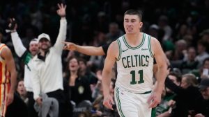Boston Celtics guard Payton Pritchard (11) celebrates after hitting a 3-point basket against the Atlanta Hawks during the second half of an NBA basketball game, Friday, March 27, 2026, in Boston. (AP Photo/Charles Krupa)