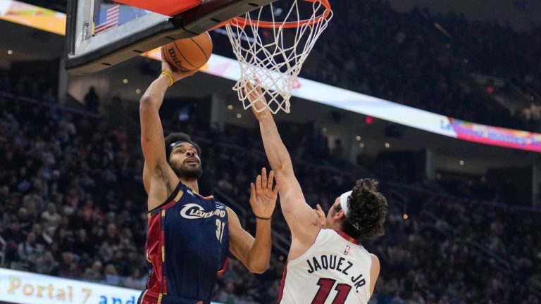 Cleveland Cavaliers center Jarrett Allen (31) goes up for a dunk in front of Miami Heat forward Jaime Jaquez Jr. (11) in the first half of an NBA basketball game in Cleveland, Friday, March 27, 2026. (AP Photo/Sue Ogrocki)
