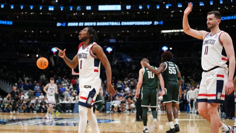 UConn guard Malachi Smith (0) and UConn forward Alex Karaban (11) celebrate their win against Michigan State in the Sweet 16 of the NCAA college basketball tournament, Saturday, March 28, 2026, in Washington. (AP Photo/Abbie Parr)