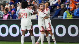 Toronto FC forward Dániel Sallói (20) celebrates with teammates Deandre Kerr (29) and Djordje Mihailović (10) during the second half of an MLS soccer match against FC Cincinnati in Cincinnati, Sunday, March 8, 2026. (AP Photo/Carolyn Kaster)