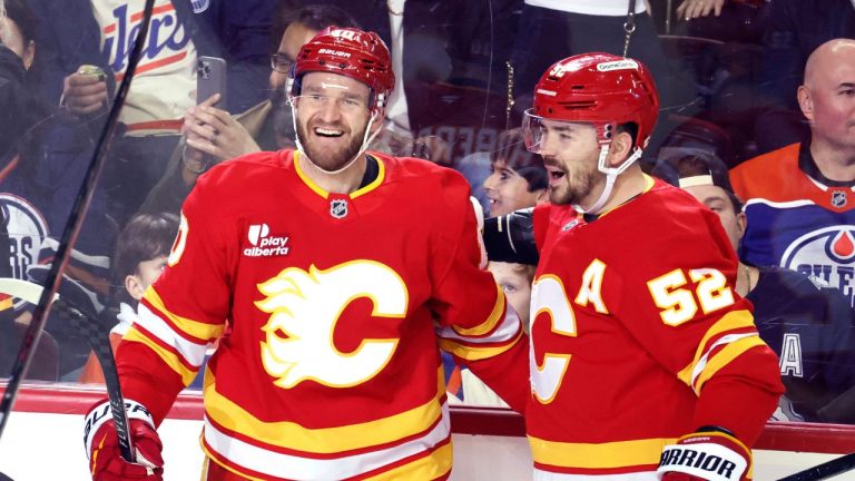 Calgary Flames' Jonathan Huberdeau, left, celebrates a goal with MacKenzie Weegar against the Edmonton Oilers during first period NHL action in Calgary, Wednesday, Feb. 4, 2026. (CP/Larry MacDougal)