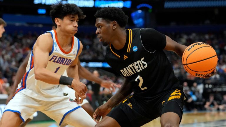 Prairie View A M guard Dontae Horne (2) tries to get around Florida guard Xaivian Lee (1) during the first half in the first round of the NCAA college basketball tournament Friday, March 20, 2026, in Tampa, Fla. (AP Photo/Chris O'Meara)