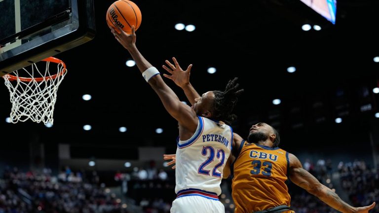 Kansas guard Darryn Peterson (22) shoots as California Baptist guard Martel Williams defends during the first half in the first round of the NCAA college basketball tournament Friday, March 20, 2026, in San Diego. (AP Photo/Mark J. Terrill)