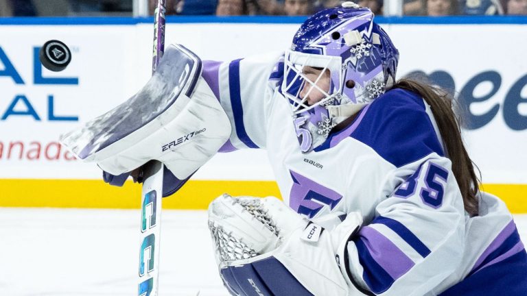 Minnesota Frost goaltender Maddie Rooney (35) stops the puck against the Vancouver Goldeneyes during third period PWHL hockey action in Vancouver on Saturday, March 21, 2026. THE CANADIAN PRESS/Ethan Cairns