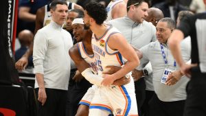Oklahoma City Thunder guard Shai Gilgeous-Alexander, center left, grabs teammate guard Ajay Mitchell (25) after a scuffle with the Washington Wizards during the first half of an NBA basketball game, Saturday, March 21, 2026, in Washington. (AP Photo/Nick Wass)