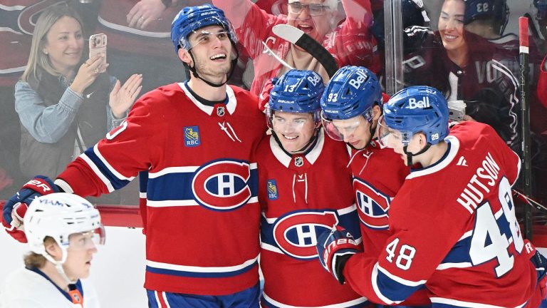 Montreal Canadiens' Cole Caufield (13) celebrates his third goal against the New York Islanders with teammates Juraj Slafkovsky (20) Ivan Demidov (93) and Lane Hutson (48) during third NHL hockey action in Montreal, Saturday, March 21, 2026. (Graham Hughes/CP)