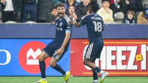 Vancouver Whitecaps' Thomas Muller, left, and Edier Ocampo celebrate Muller's second goal against Toronto FC during the first half of an MLS soccer match, in Vancouver, on Saturday, Feb. 28, 2026. (Darryl Dyck/CP)