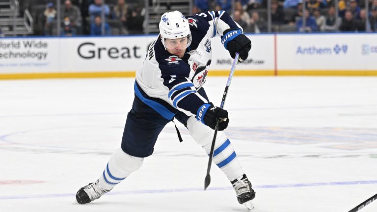 Winnipeg Jets defenseman Luke Schenn (5) takes a shot against the St. Louis Blues during the third period of an NHL hockey game on Wednesday, Dec. 17, 2025, in St. Louis. (Joe Puetz/AP)