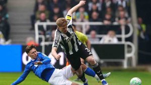 Sunderland's Chris Rigg, left, and Newcastle United's Lewis Hall battle for the ball during the Premier League match between Newcastle and Sunderland outside St James' Park, Newcastle upon Tyne, England, Sunday March 22, 2026. (Owen Humphreys/PA via AP)