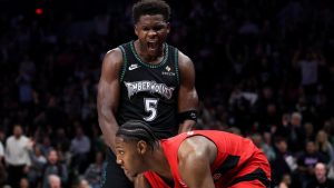 Minnesota Timberwolves guard Anthony Edwards celebrates his dunk in front of Toronto Raptors forward RJ Barrett during the second half of an NBA game Thursday, March 5, 2026, in Minneapolis. (AP/Matt Krohn)