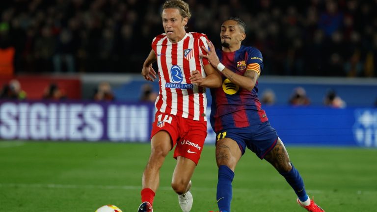 Atletico Madrid's Marcos Llorente, left, and Barcelona's Raphina challenge for the ball during the Copa del Rey semifinal second leg match between Barcelona and Atletico Madrid in Barcelona, Spain, Tuesday, March 3, 2026. (AP/Joan Monfort)