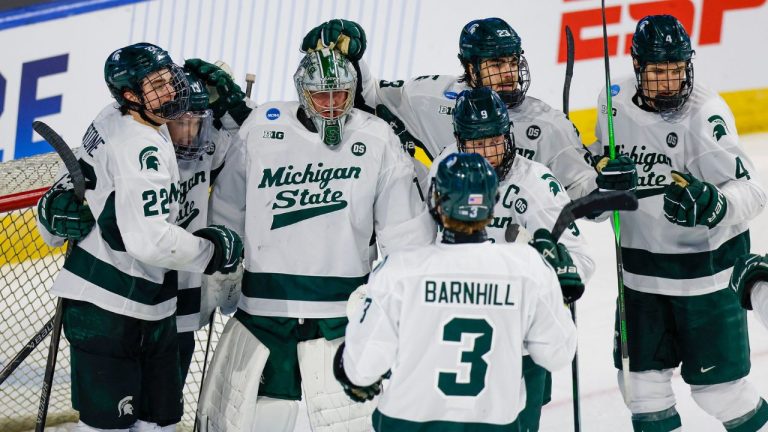 Michigan State goalie Trey Augustine (1) is surrounded by teammates after defeating UConn in an NCAA hockey regional game on Thursday, March 26, 2026, in Worcester, Mass. (Greg M. Cooper/AP Photo)