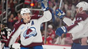 Colorado Avalanche centre Nathan MacKinnon, left, and right wing Valeri Nichushkin (13) celebrate after a goal by center Martin Necas during the first period of an NHL hockey game against the Chicago Blackhawks, Friday, March 20, 2026, in Chicago. (Erin Hooley/AP)